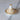Petit Tajine ceramic Moroccan-inspired clay cooking pot with earthy terracotta color and ornate metal lid.