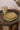 Plateaux Ronds Empreinte Kaki Gold ceramic plate with embossed kaki brown and gold finish.